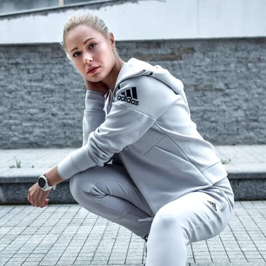 Young woman in grey Adidas track suit, sporty